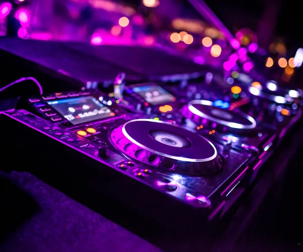 Un controlador de DJ iluminado en magenta y violeta.